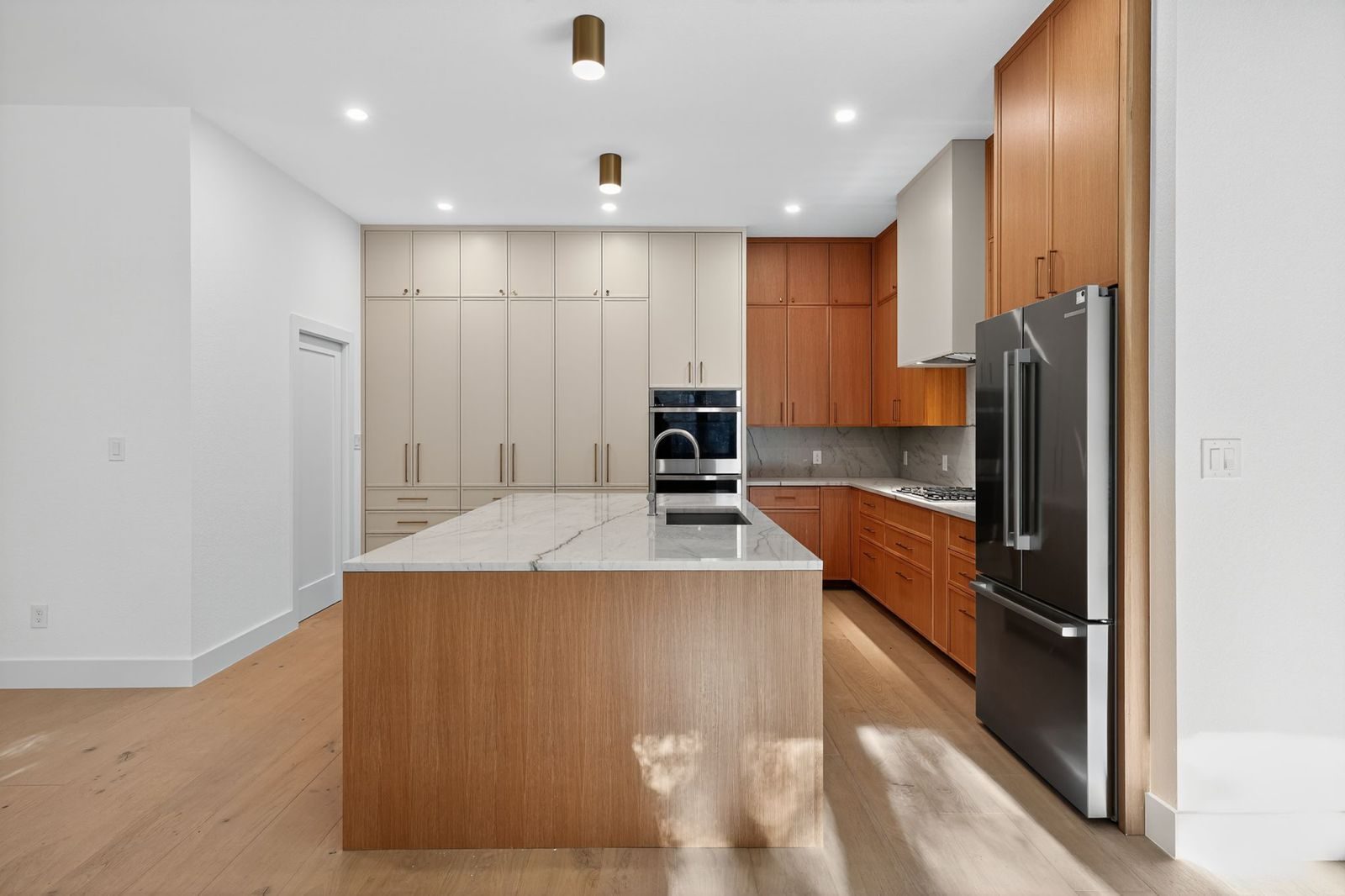 Along Creek Cove finished kitchen, wide view with pantry wall and refrigerator, Avery Ranch, Austin, TX