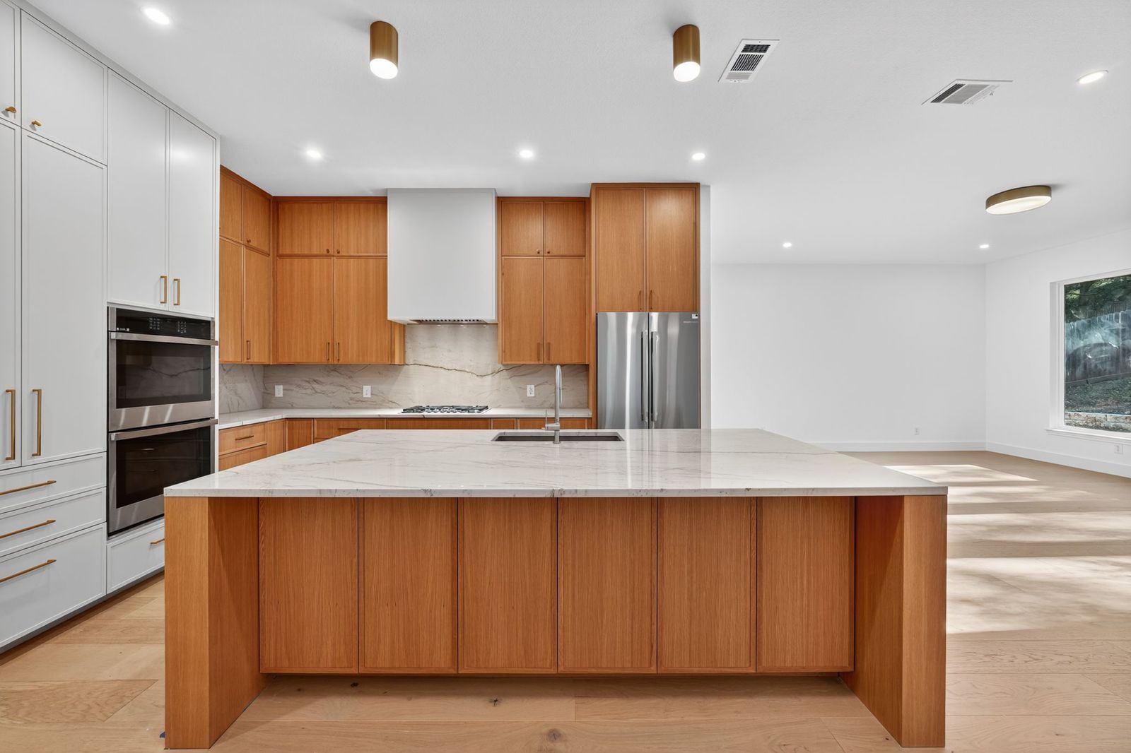 Along Creek Cove finished kitchen with marble waterfall island, Avery Ranch, Austin, TX