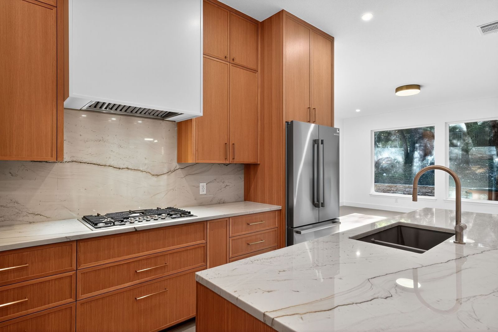Along Creek Cove finished kitchen range wall and island, Avery Ranch, Austin, TX