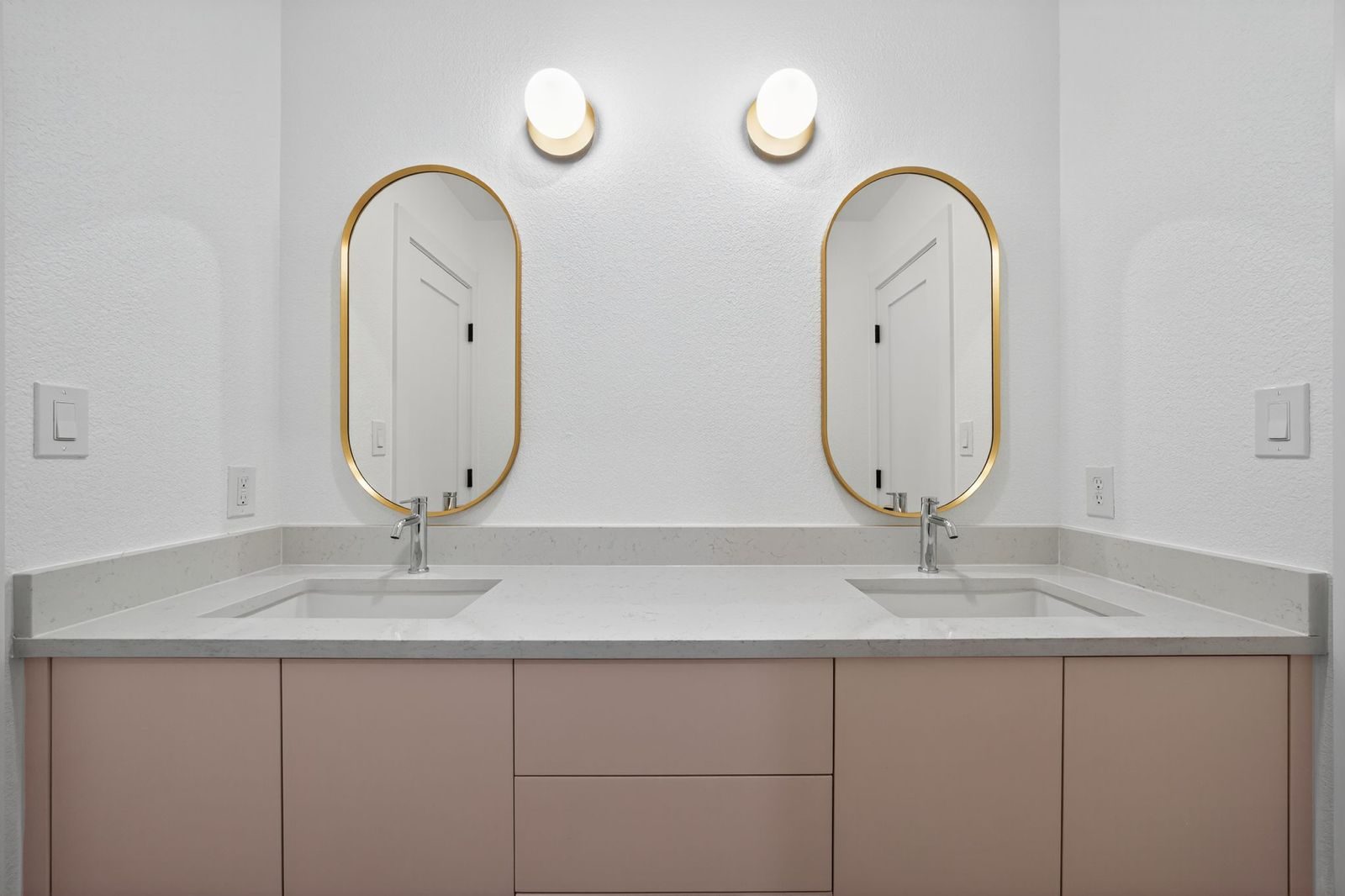 Along Creek Cove finished powder bathroom with oval mirrors, Avery Ranch, Austin, TX