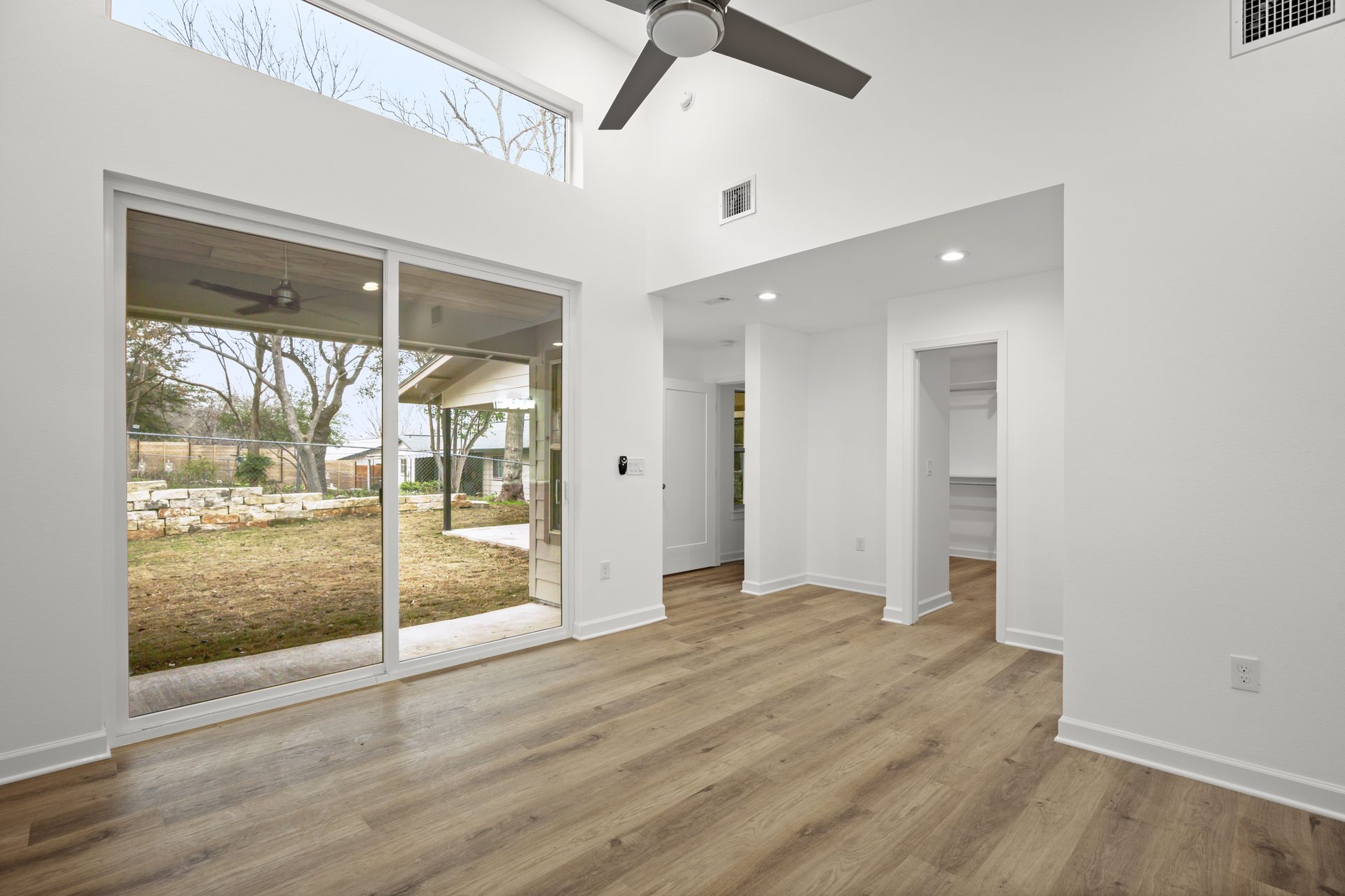 South Congress home addition, living space with vaulted ceiling and sliding glass door, Austin, TX