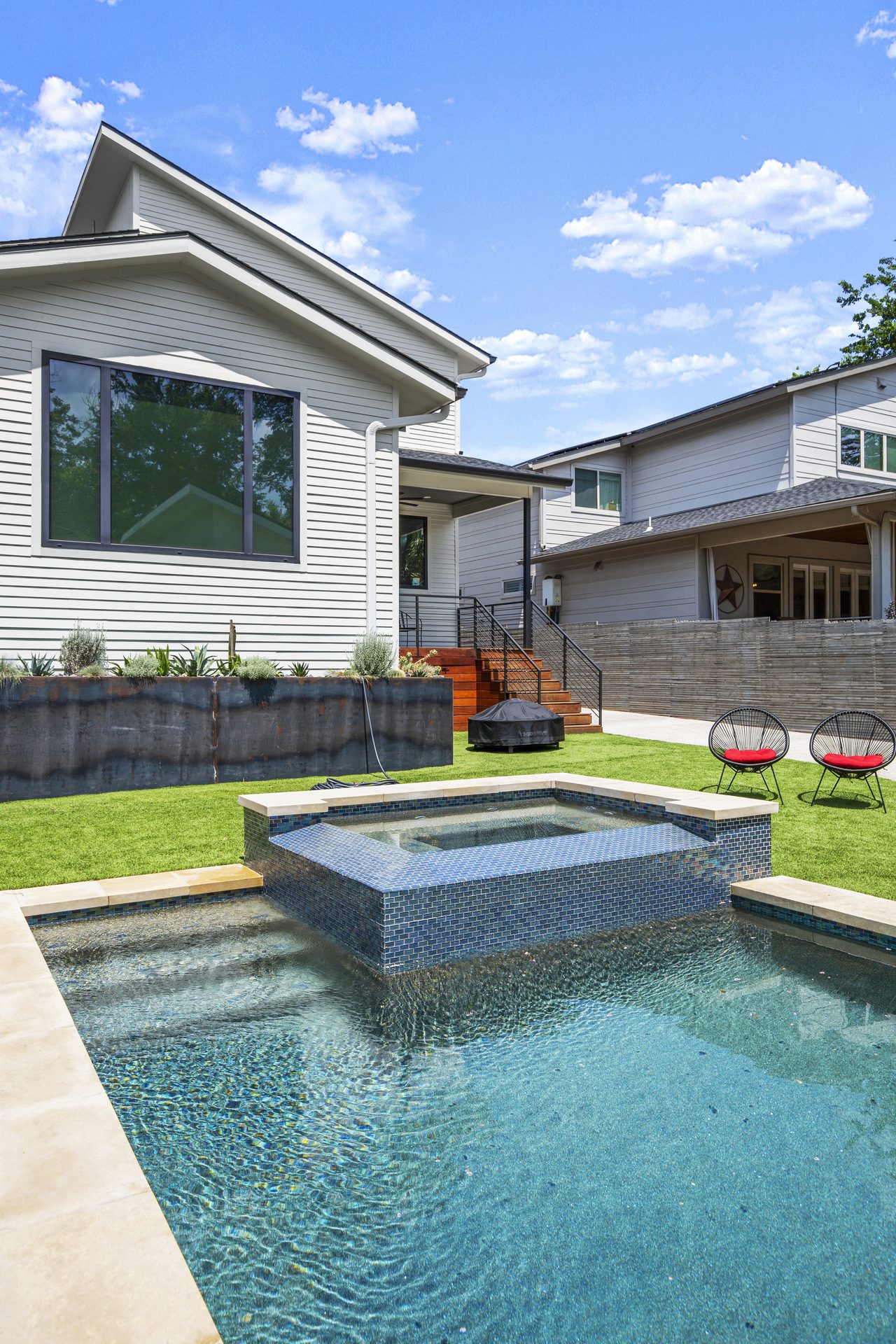 Tarrytown pool and outdoor living, spa and patio steps toward main house, Austin, TX