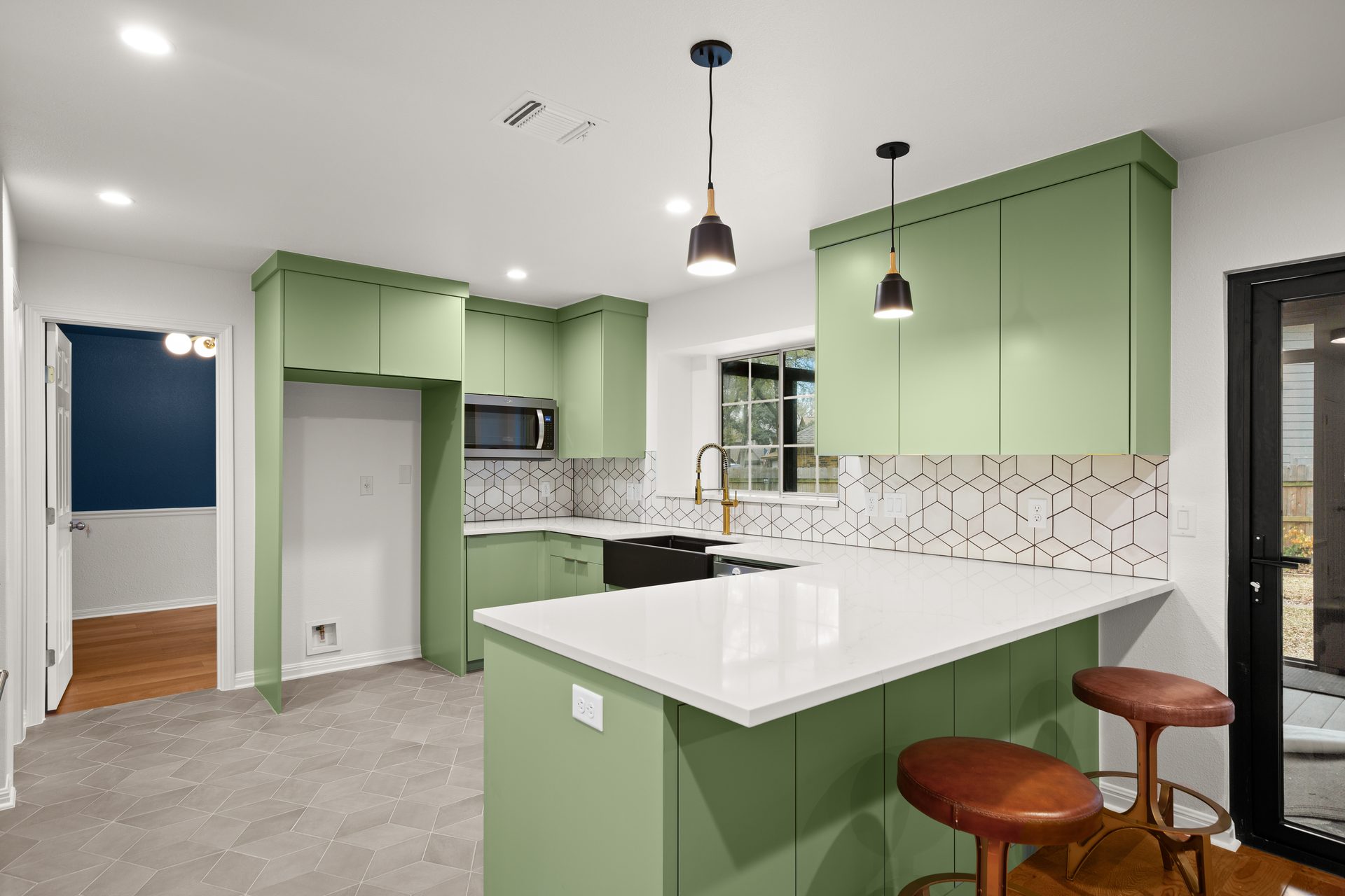 Anderson Mill (Los Indios) home renovation, kitchen with green cabinetry and hex tile backsplash, NW Austin, TX