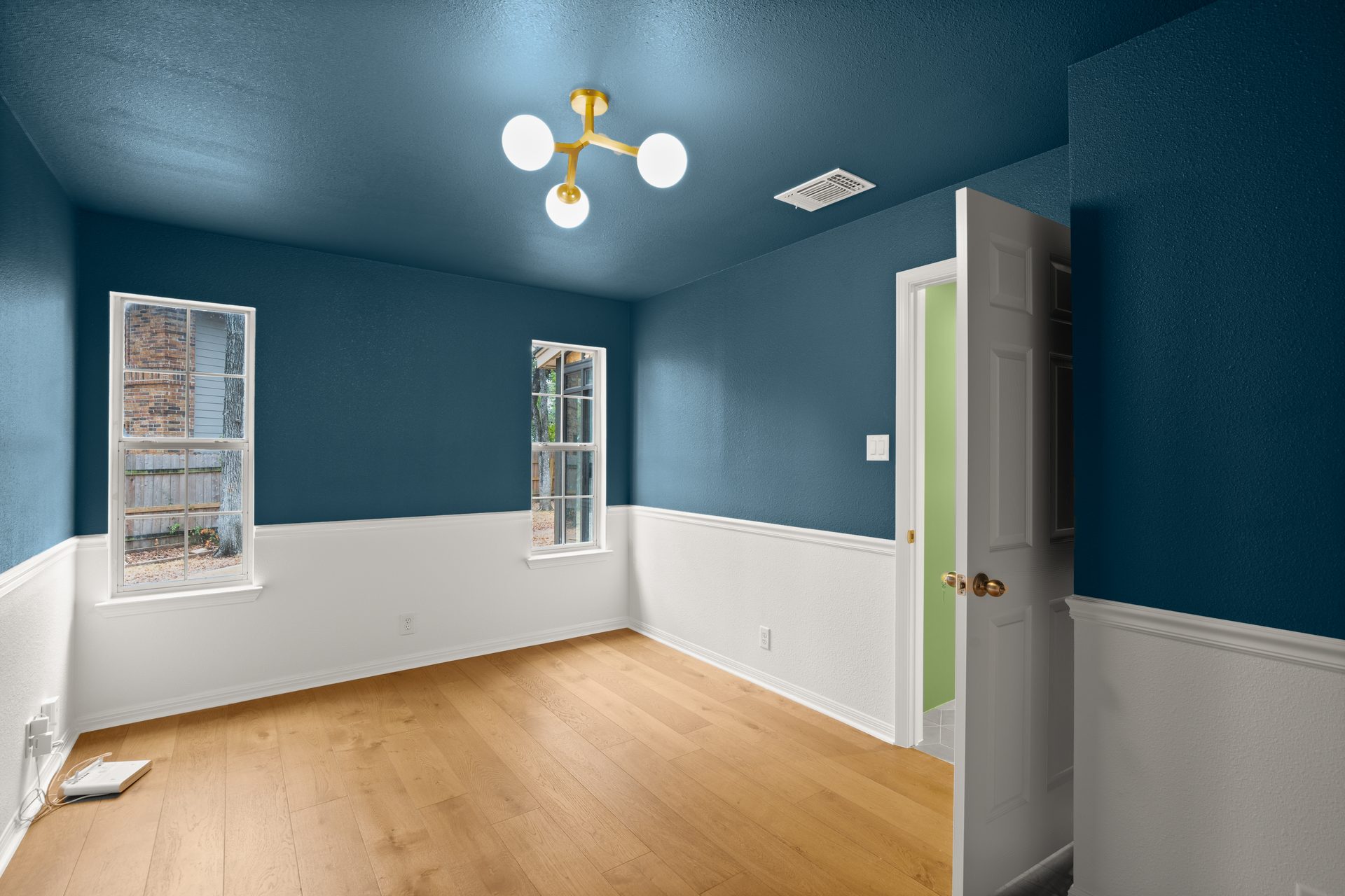 Anderson Mill (Los Indios) home renovation, navy accent bedroom with bay windows, NW Austin, TX