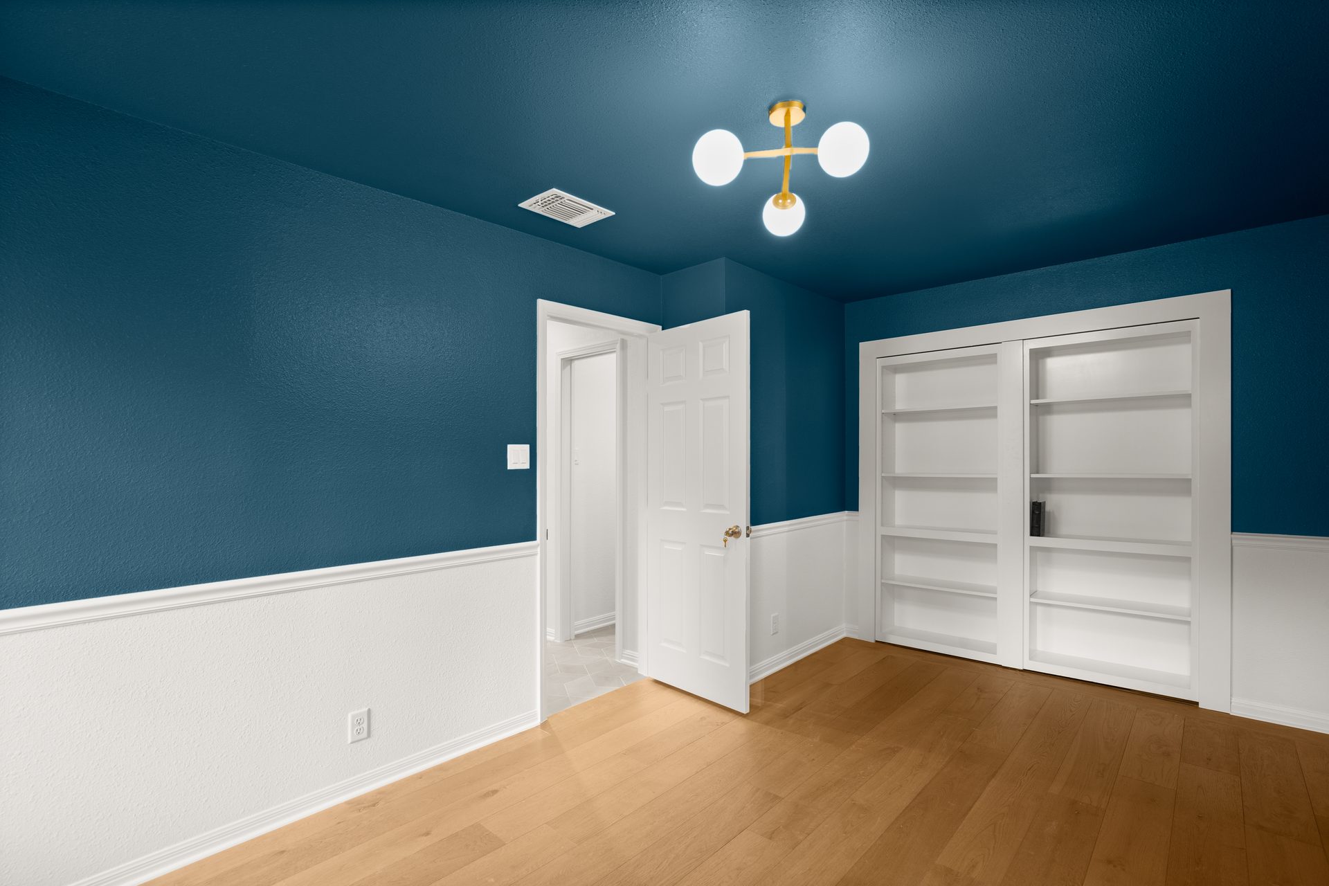 Anderson Mill (Los Indios) home renovation, navy accent bedroom built-in bookcase, NW Austin, TX