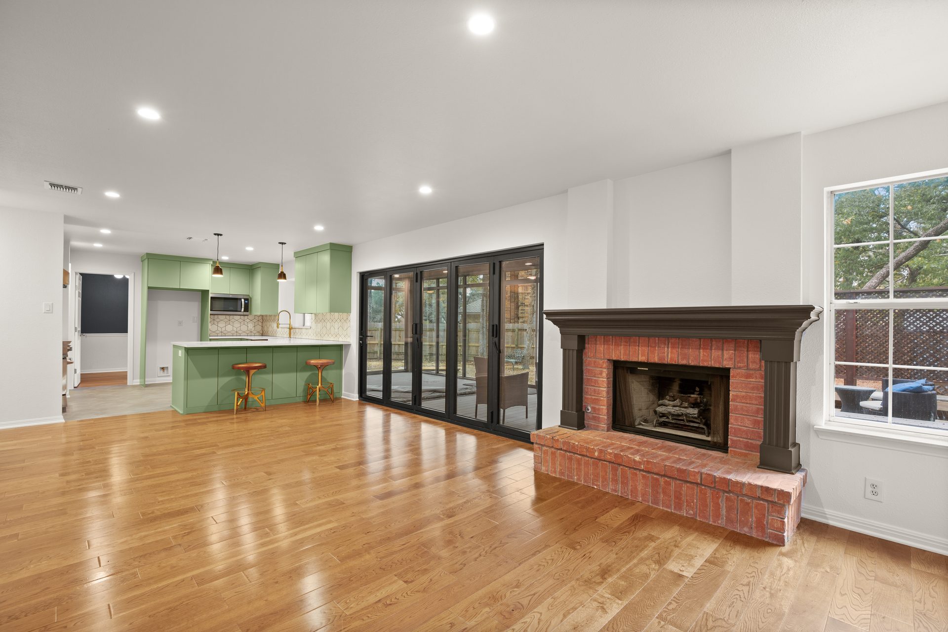 Anderson Mill (Los Indios) home renovation, open concept view with brick fireplace, NW Austin, TX