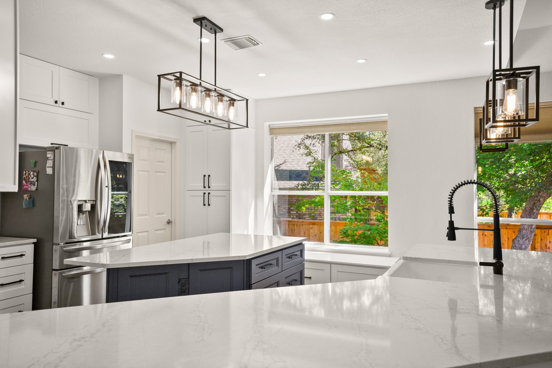 Oak Hill kitchen renovation, window seat and pendant lights view toward fridge, SW Austin, TX