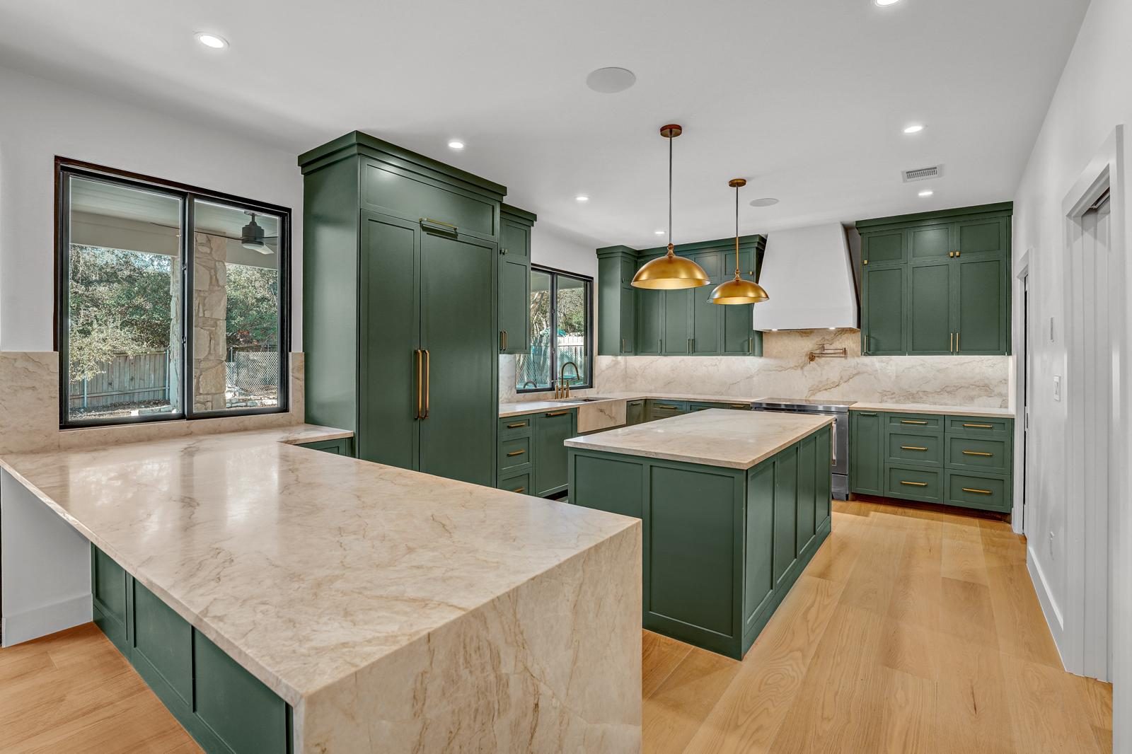 Mandeville finished kitchen with green cabinetry and waterfall island, Anderson Mill, NW Austin, TX