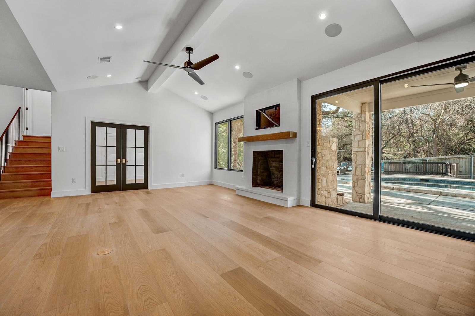 Mandeville finished living room fireplace with pool view, Anderson Mill, NW Austin, TX