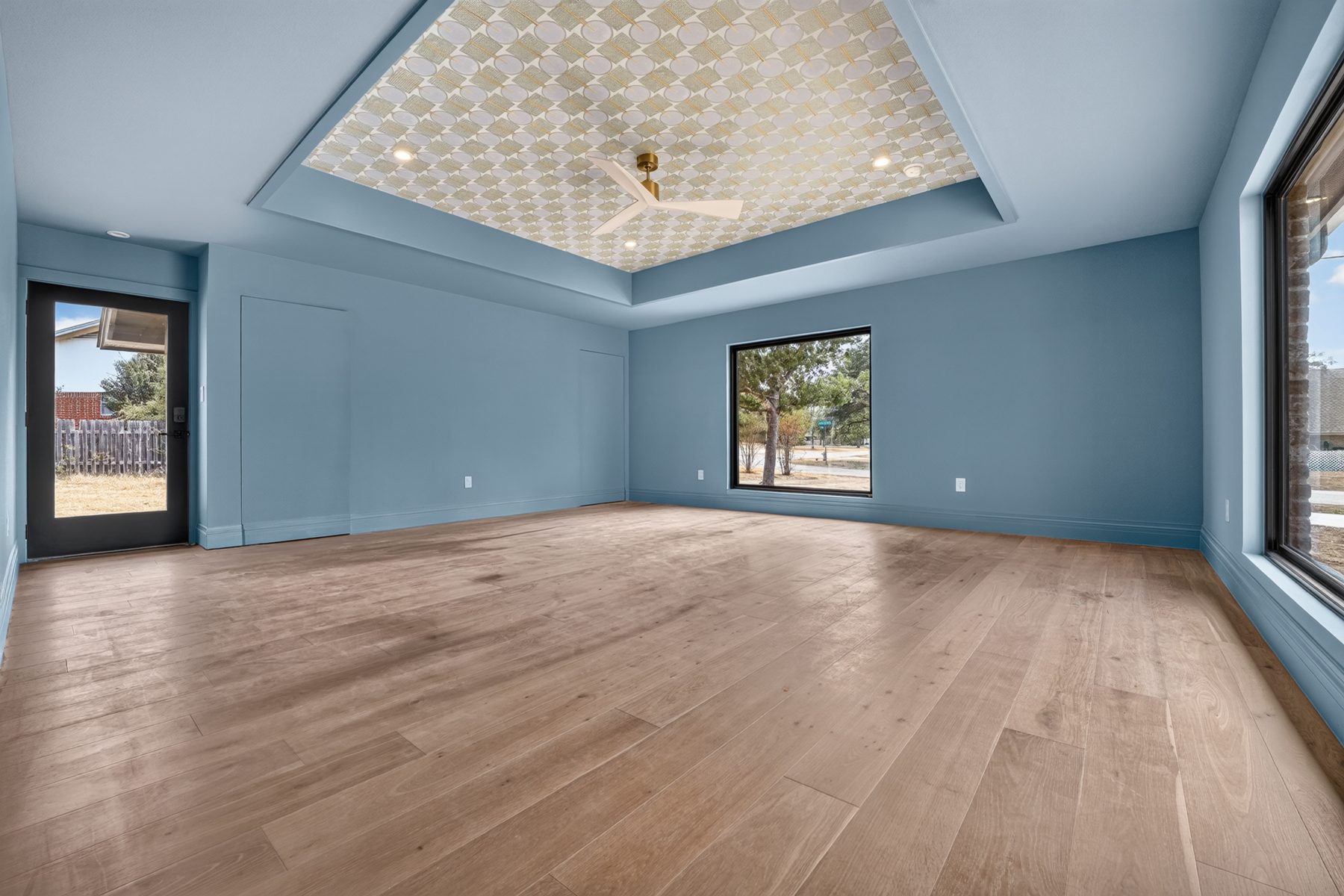 Bedroom with blue walls and patterned tray ceiling, North Austin, TX