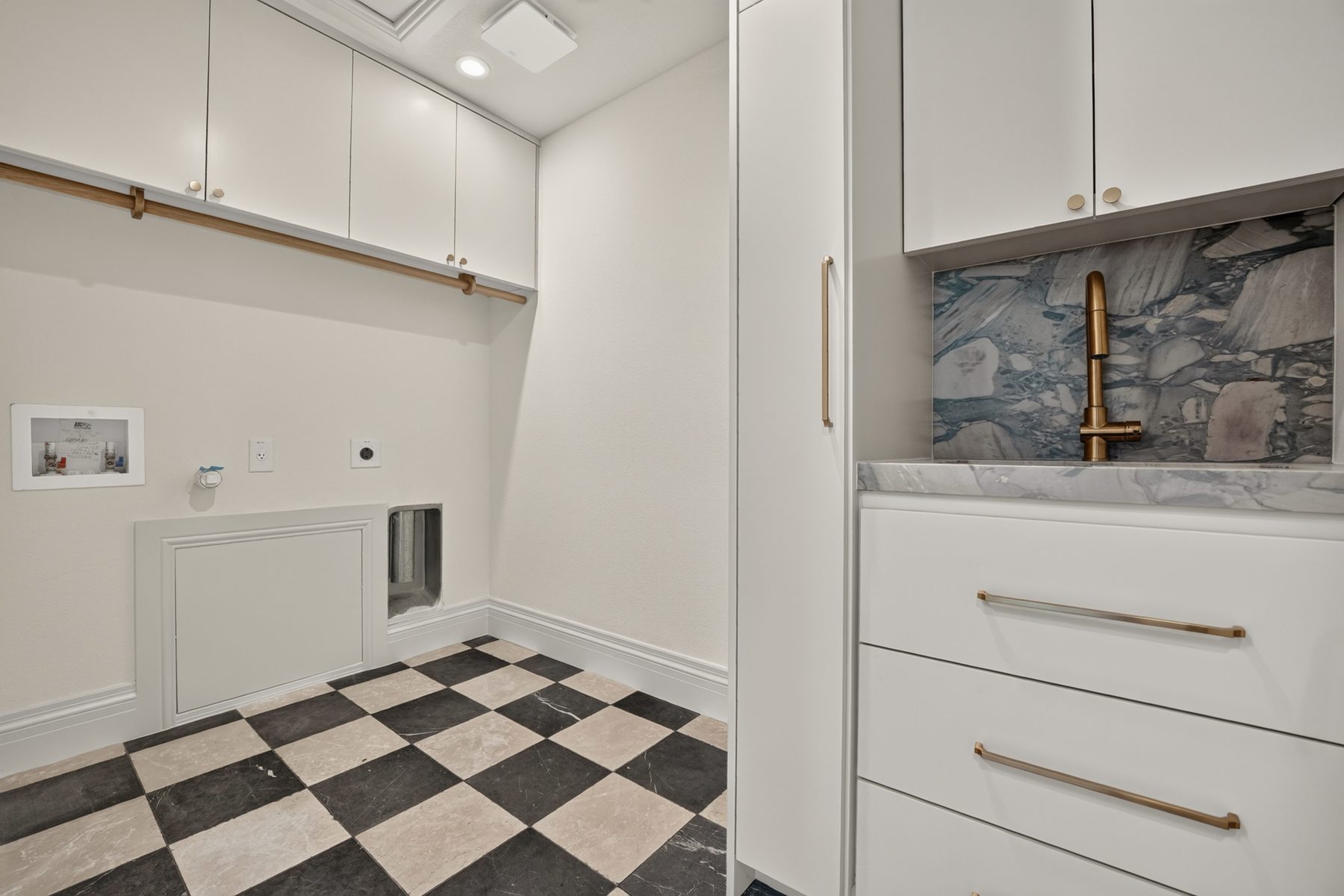 Laundry room with checkerboard floor and brass fixtures, North Austin, TX